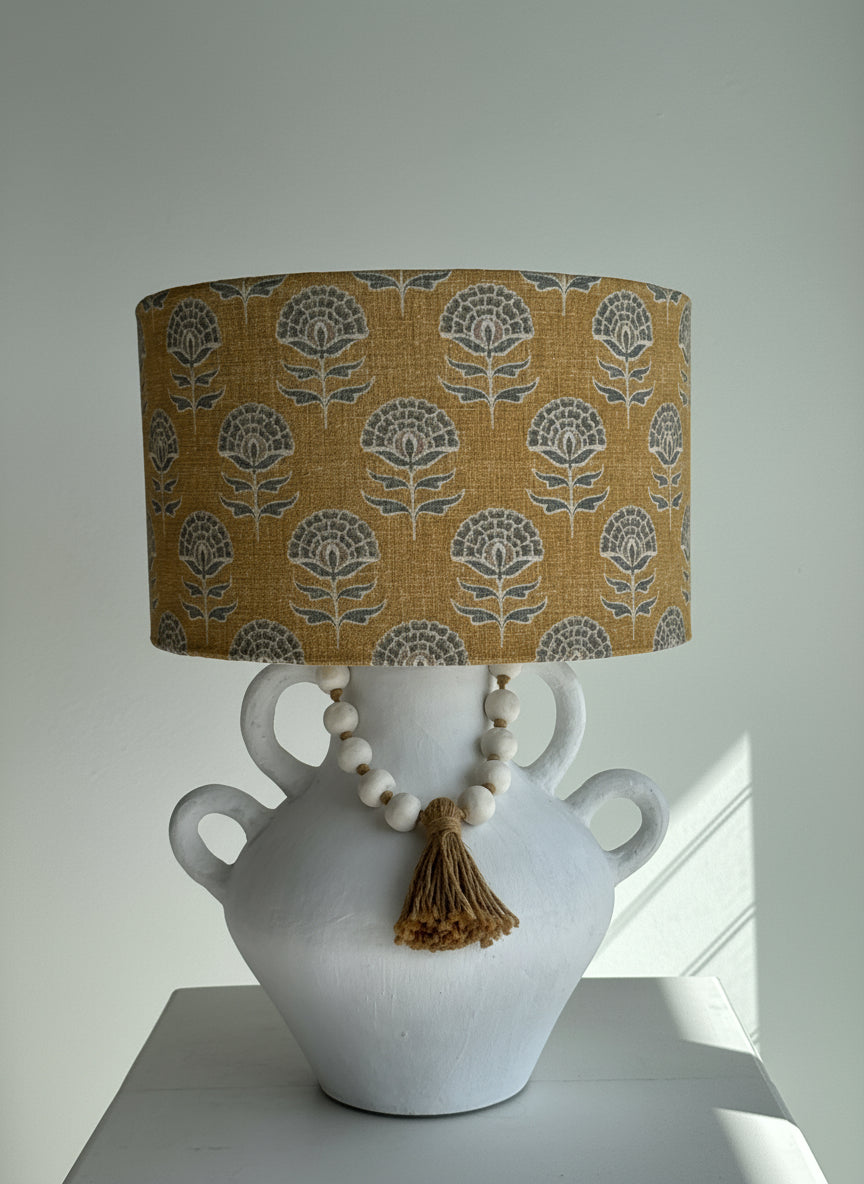 earthy coloured lampshade with a grey geometric shape
