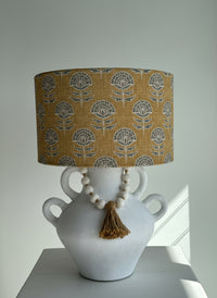 earthy coloured lampshade with a grey geometric shape
