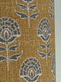 Close-up of a textured fabric with floral patterns on a gold background