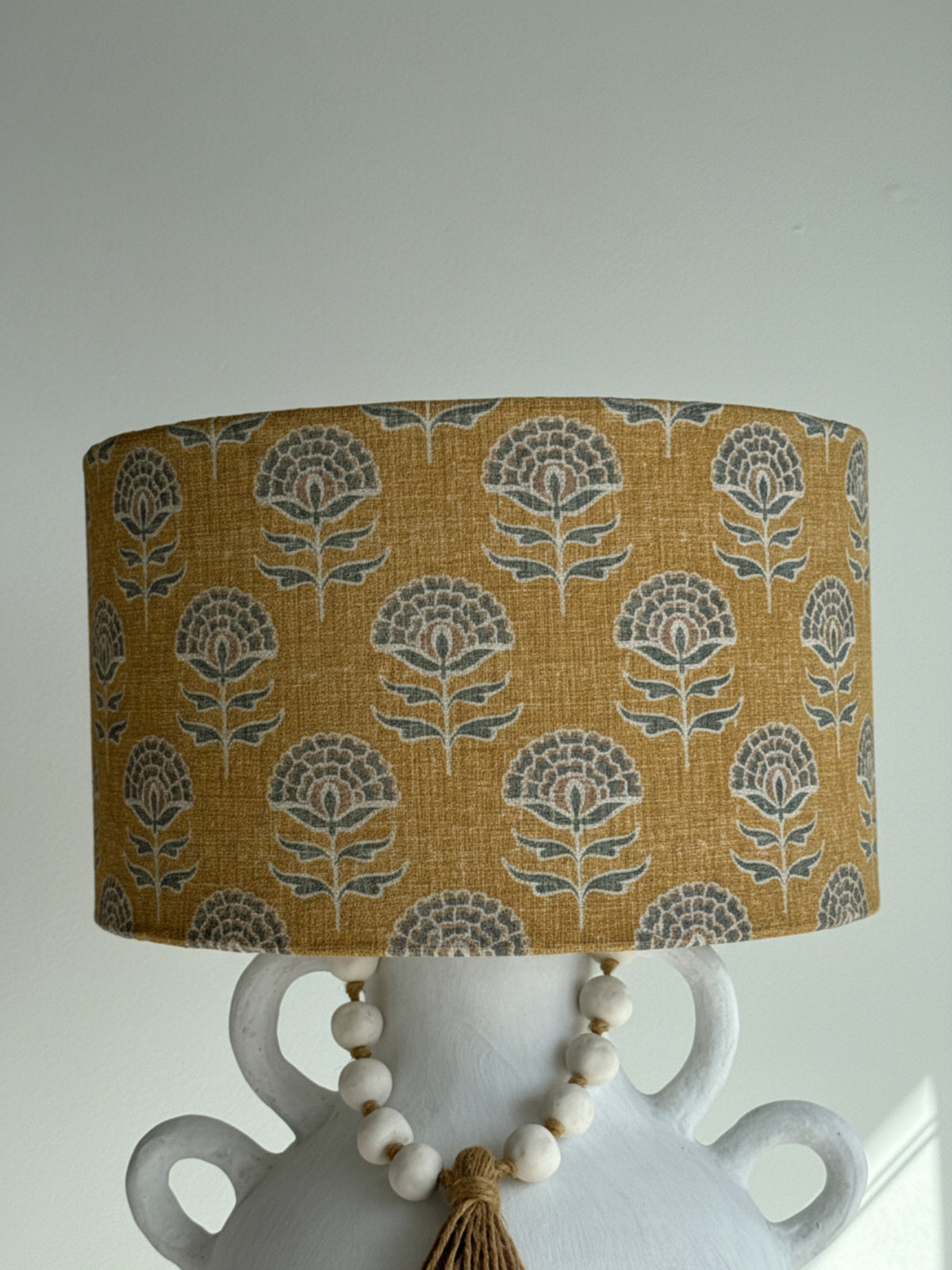 Decorative lampshade with floral pattern on a plain background