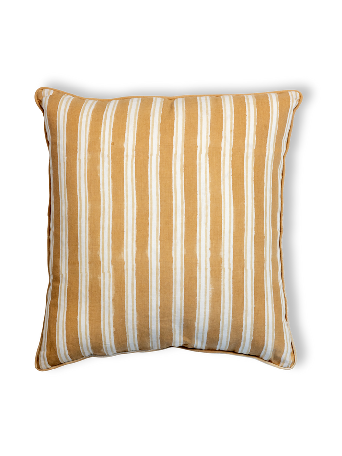 Striped pillow with yellow and white stripes on a white background