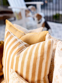 Close-up of striped pillows on a chair with a blurred background