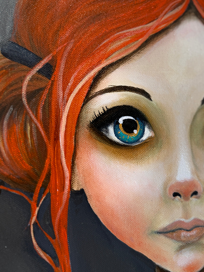 Close-up of a person with red hair and blue eyes, wearing a black headband.