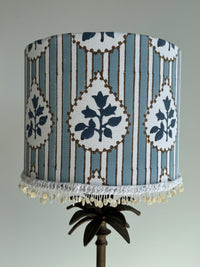 Decorative lampshade with blue and white pattern on a gray background