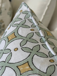 Close-up of a decorative pillow with a geometric pattern on a neutral background