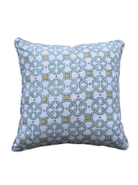Decorative pillow with geometric pattern on a tiled floor