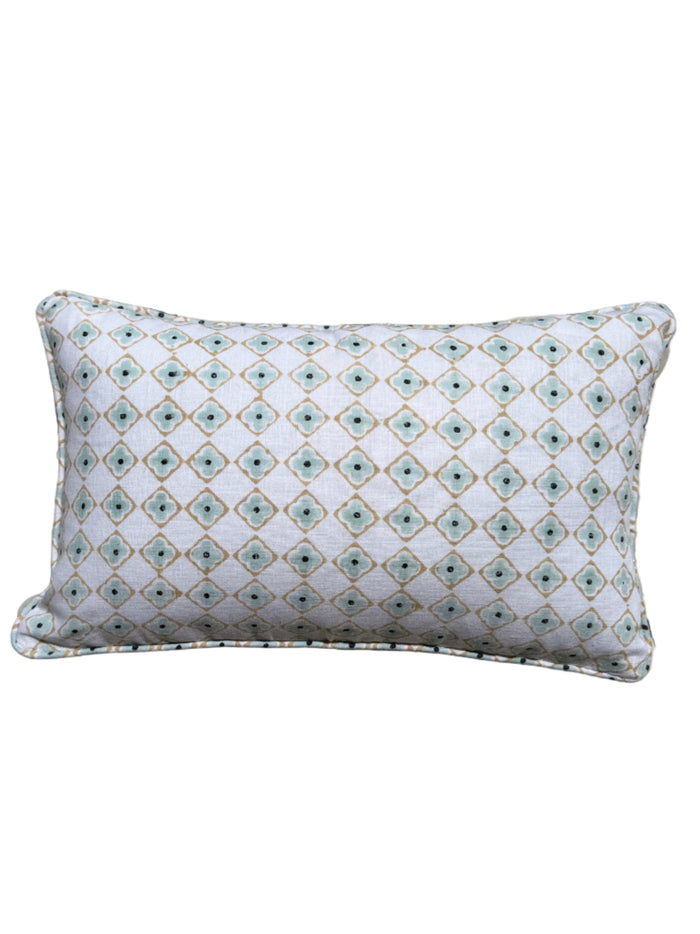 Decorative pillow on a patterned tiled floor
