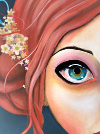 Close-up of a person's eye with pink hair and flowers, on a dark background
