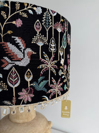 Decorative black fabric with floral and leaf patterns on a white background