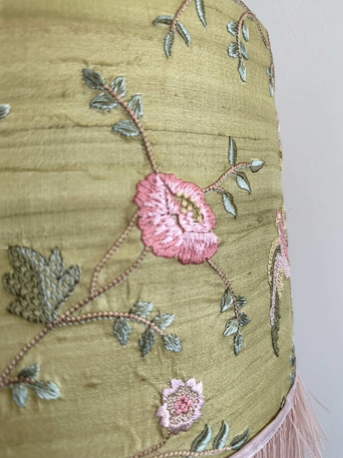 Embroidered fabric with floral patterns on a plain background
