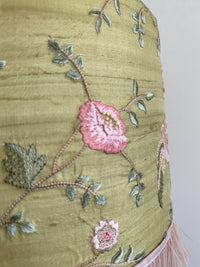 Embroidered fabric with floral patterns on a plain background