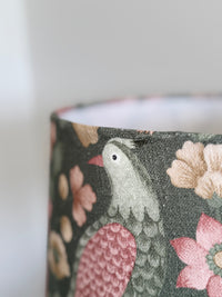 Fabric with floral and bird pattern on a dark background