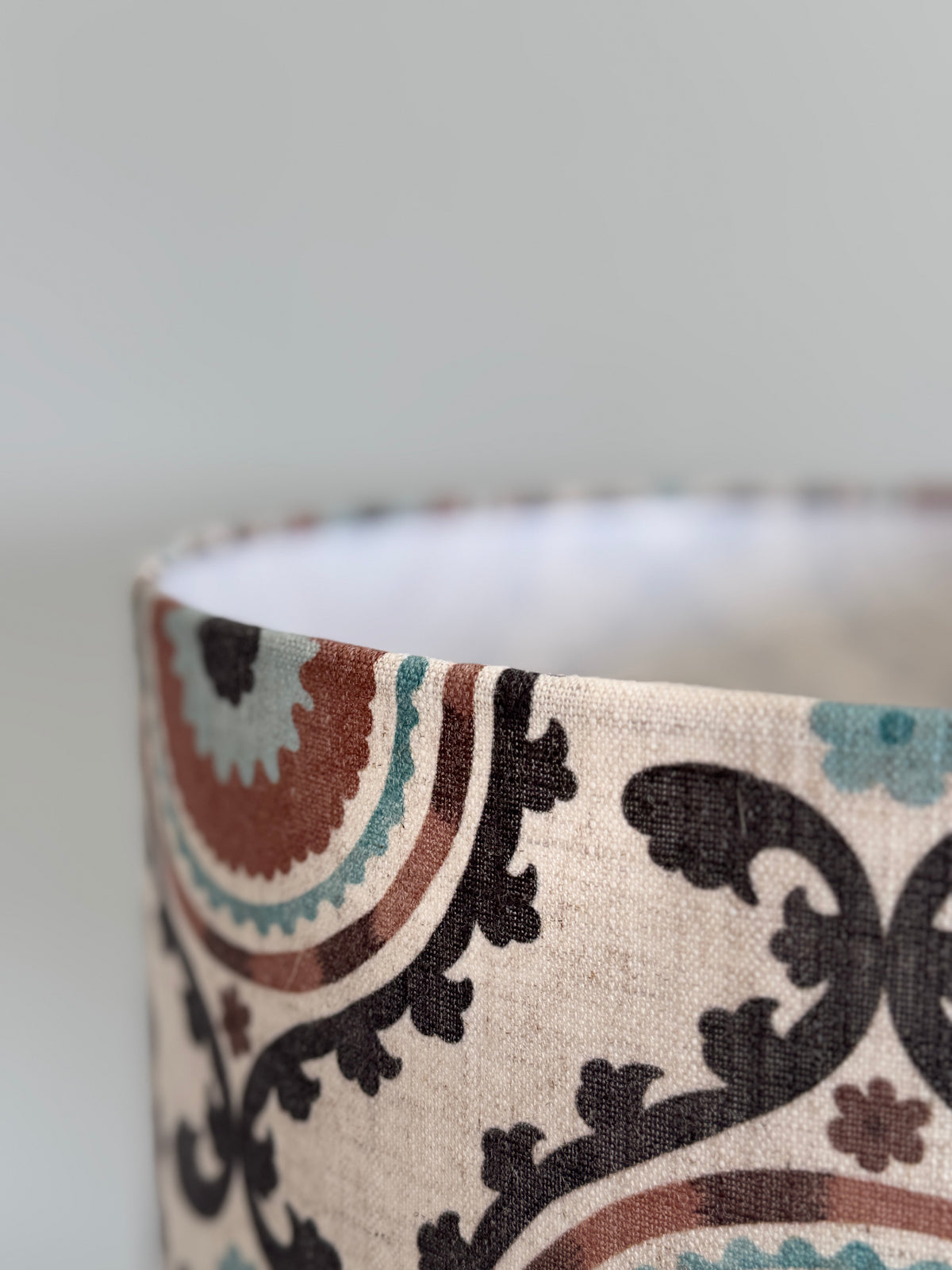 Close-up of a fabric with a decorative pattern on a plain background