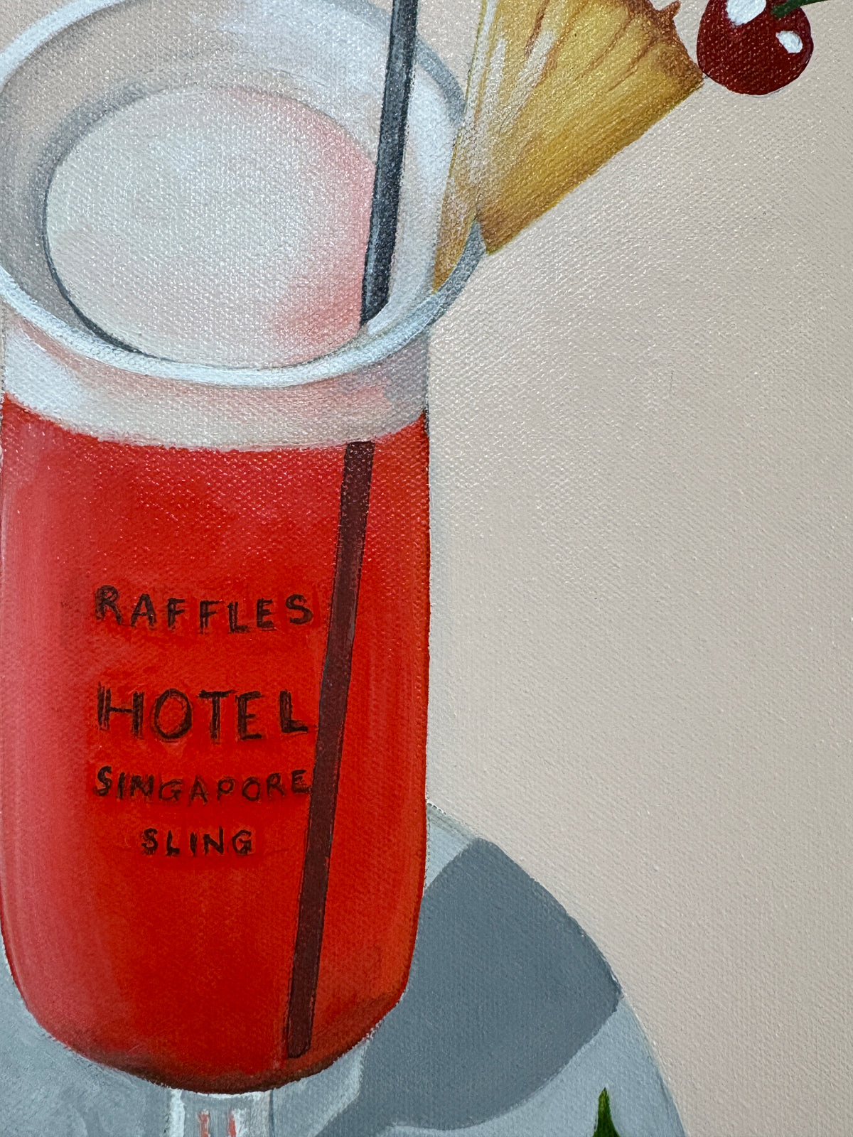 Raffles Hotel Singapore Sling bottle with cocktail ingredients on a tablecloth
