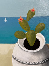 Cactus with flowers growing out of a pipe against a blue and gray background
