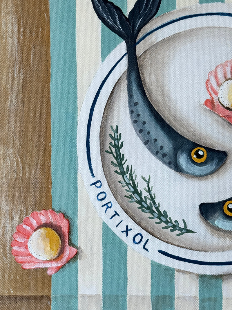 Decorative plate with fish design and 'Portixol' branding on a striped background