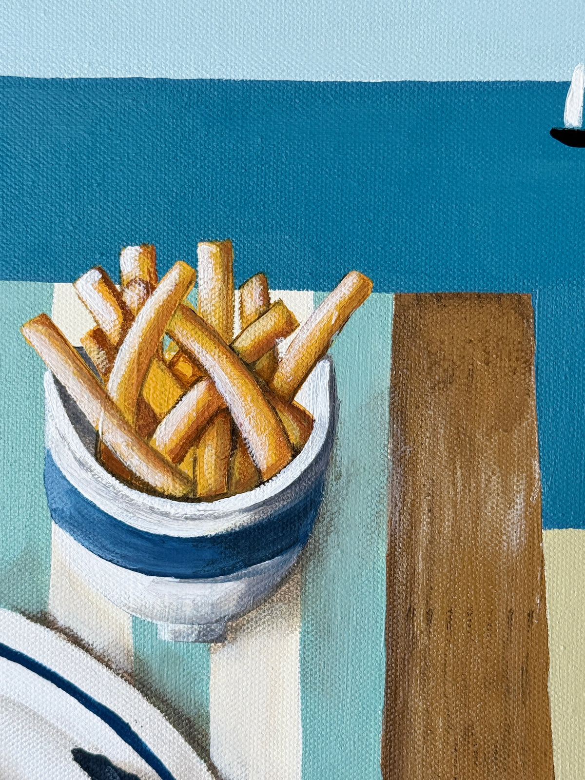 Bowl of french fries on a table with a blue background