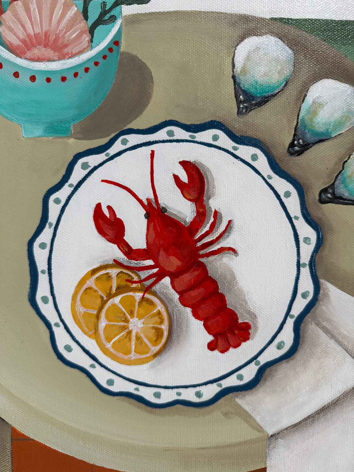 Decorative plate with a red lobster and lemon slices on a beige surface.