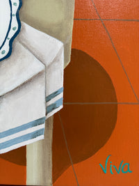 Close-up of a towel with stripes on an orange tiled floor, featuring the brand 'Viva'.