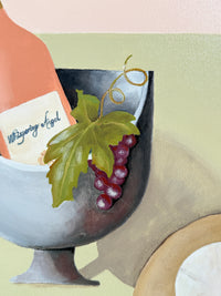Decorative item with grapes and a label on a light background