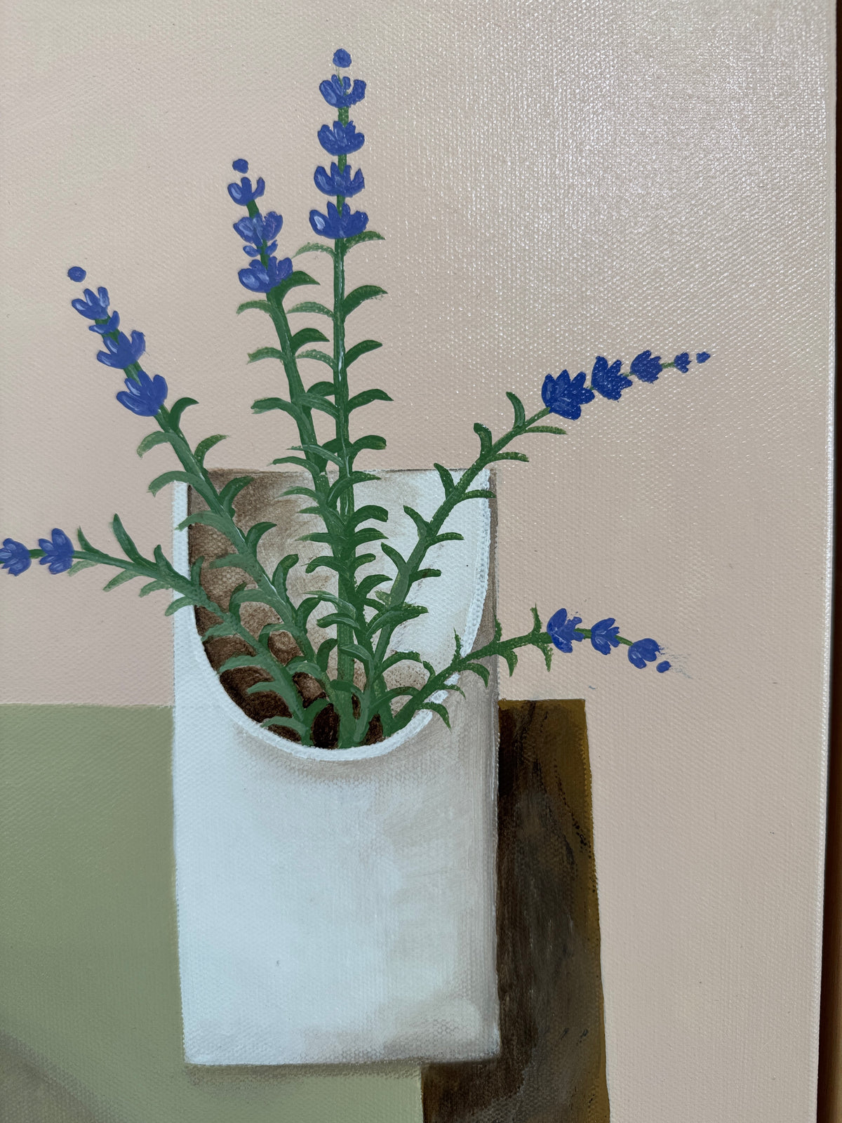 White wall-mounted planter with lavender plant against a neutral background