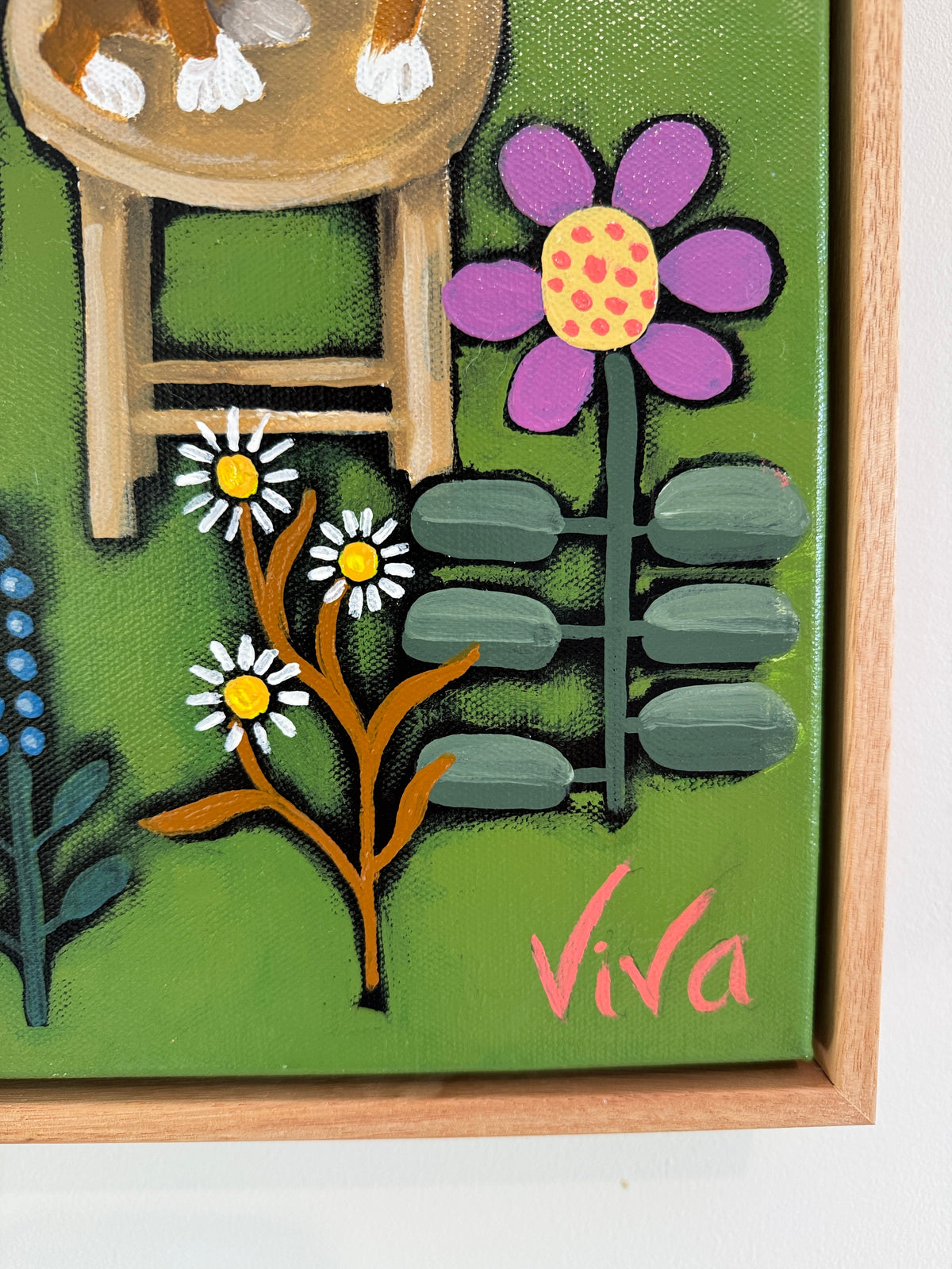 Painting of a cat on a stool with flowers and 'Viva' text on a green background