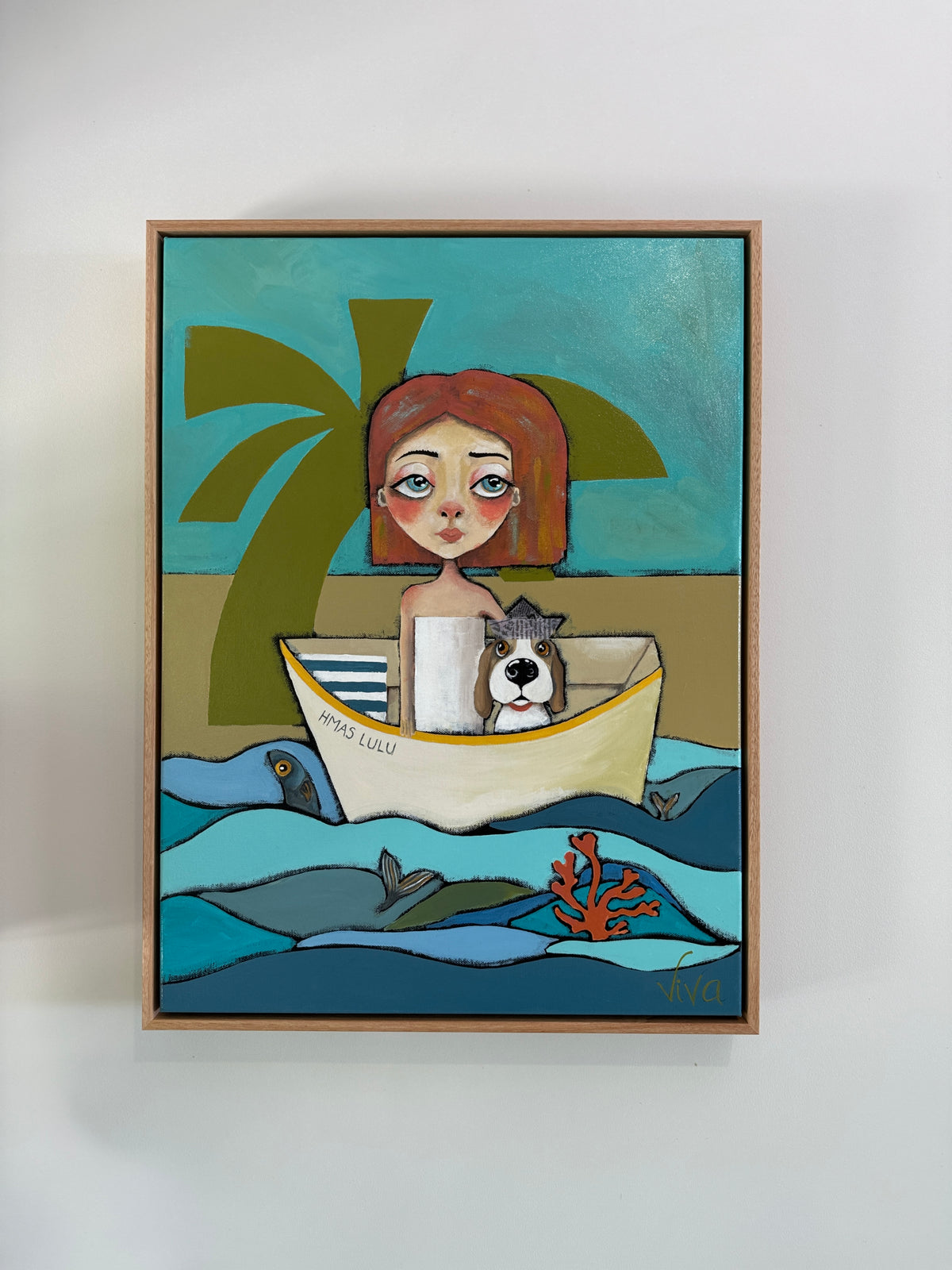 Framed artwork of a woman with a dog in a boat on a beach scene.